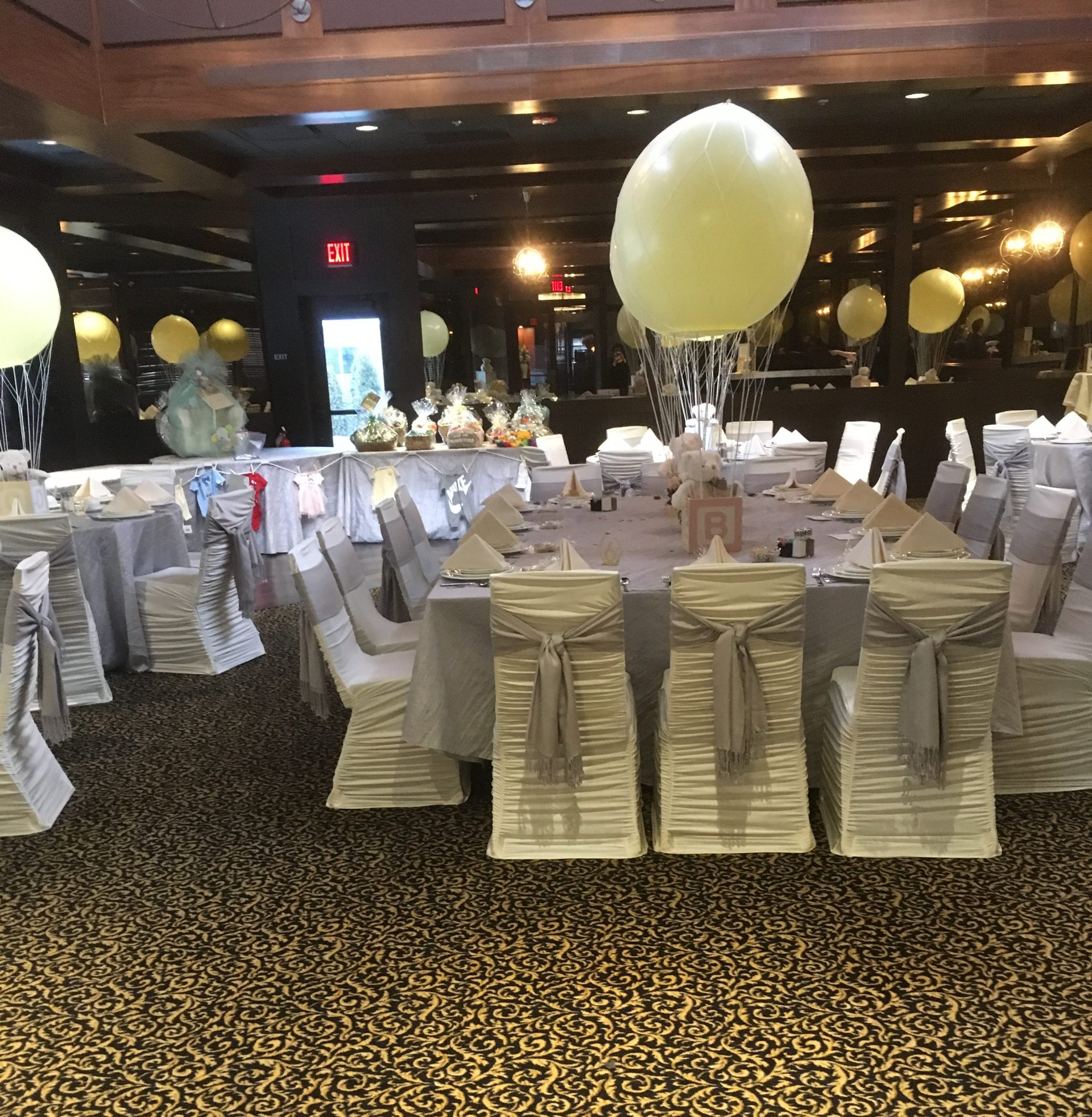 Banquet room set with balloons and silver chair covers