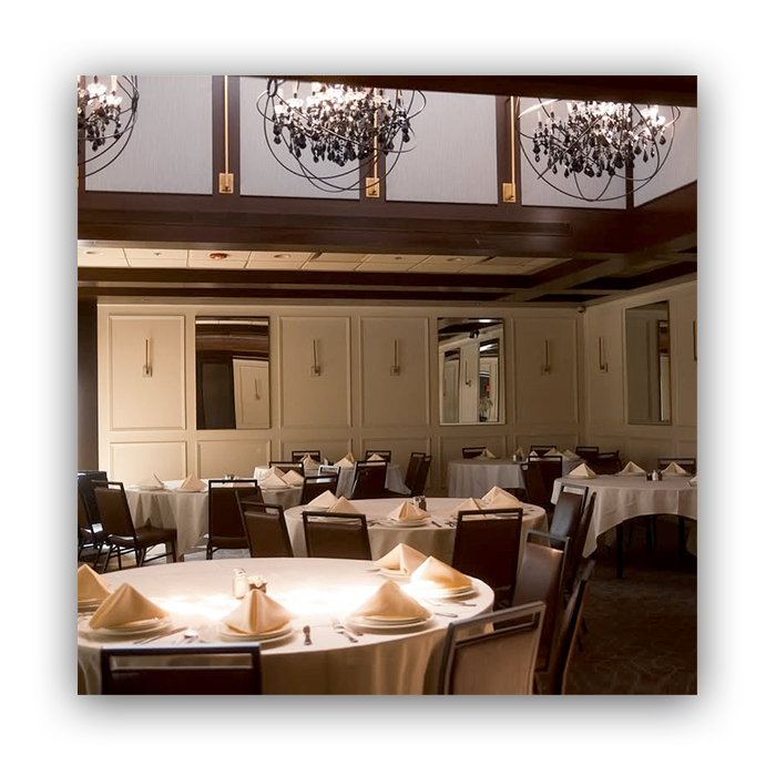 Da Francesco's banquet dining room set with white linens and chandeliers
