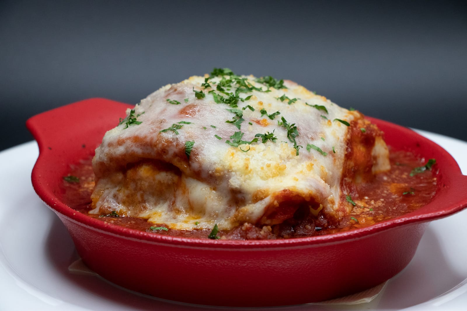 Baked lasagna with melted cheese in marinara