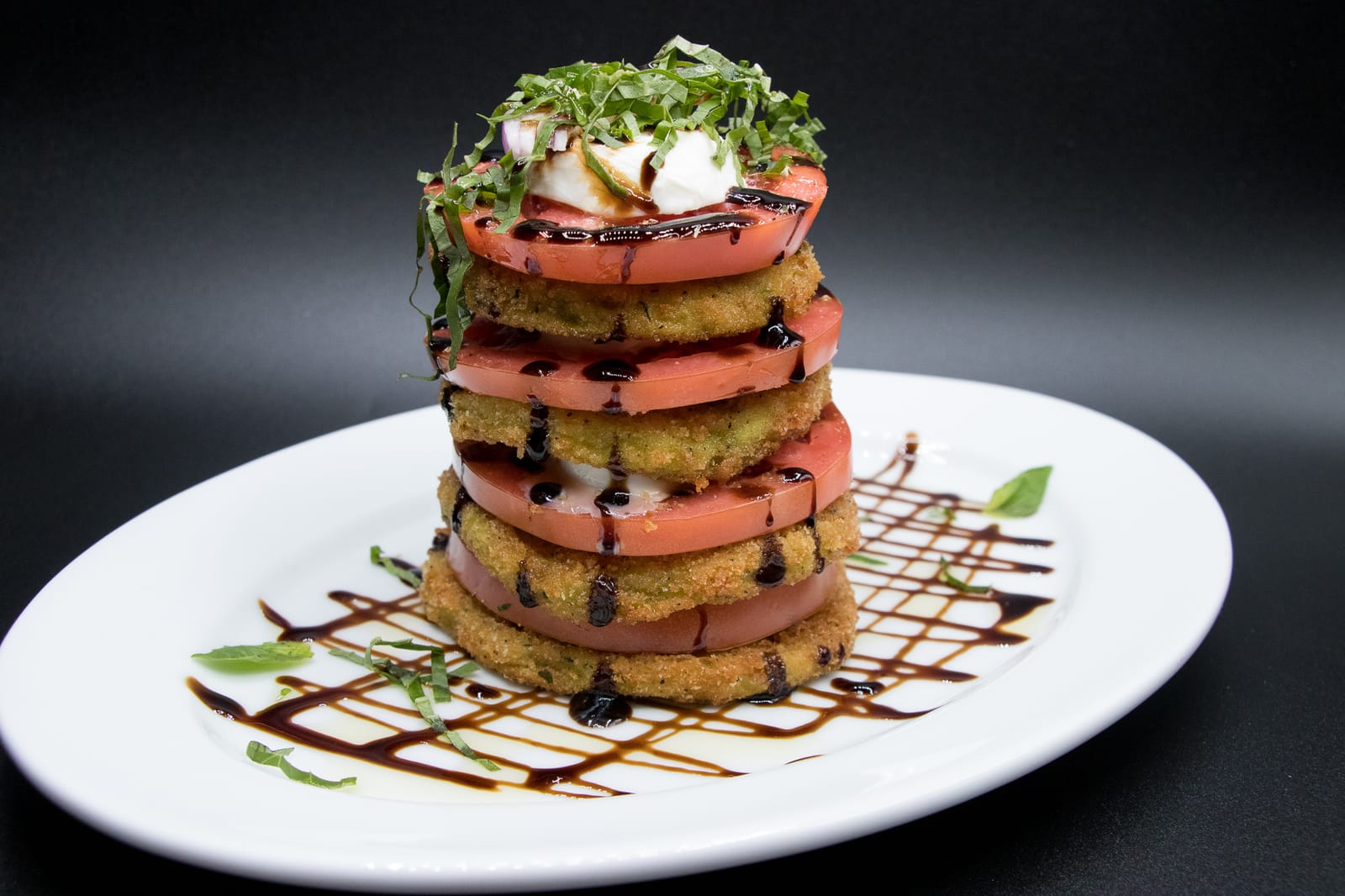 Stacked tomato caprese with mozzarella and balsamic