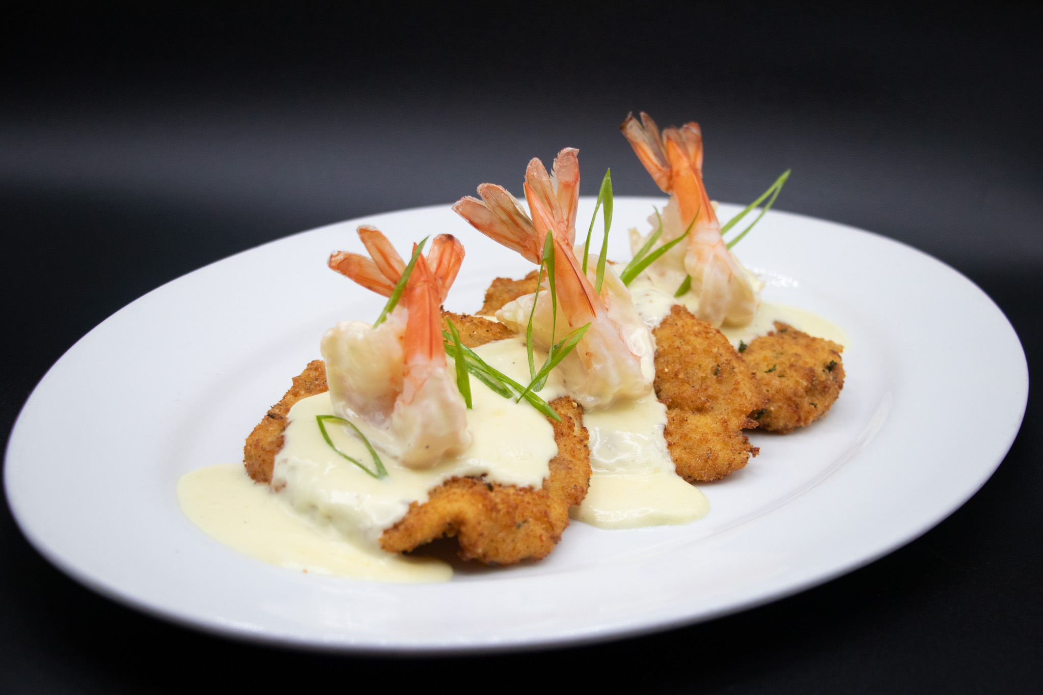 Pollo Caruso — breaded chicken medallions topped with jumbo shrimp